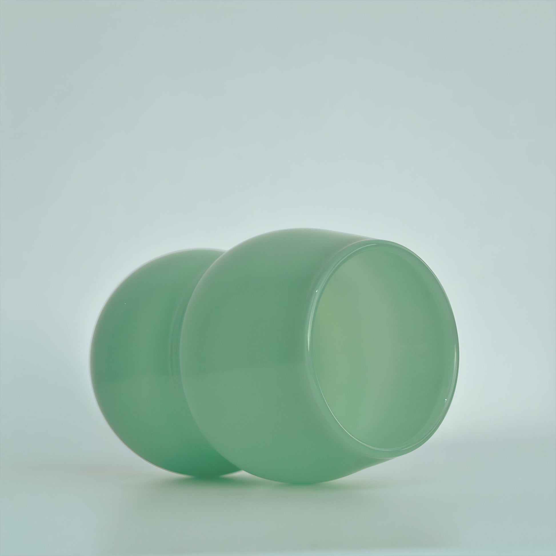 A handcrafted cup from the Dreamlike Collection, featuring whimsical curves and a vibrant interplay of color and light.