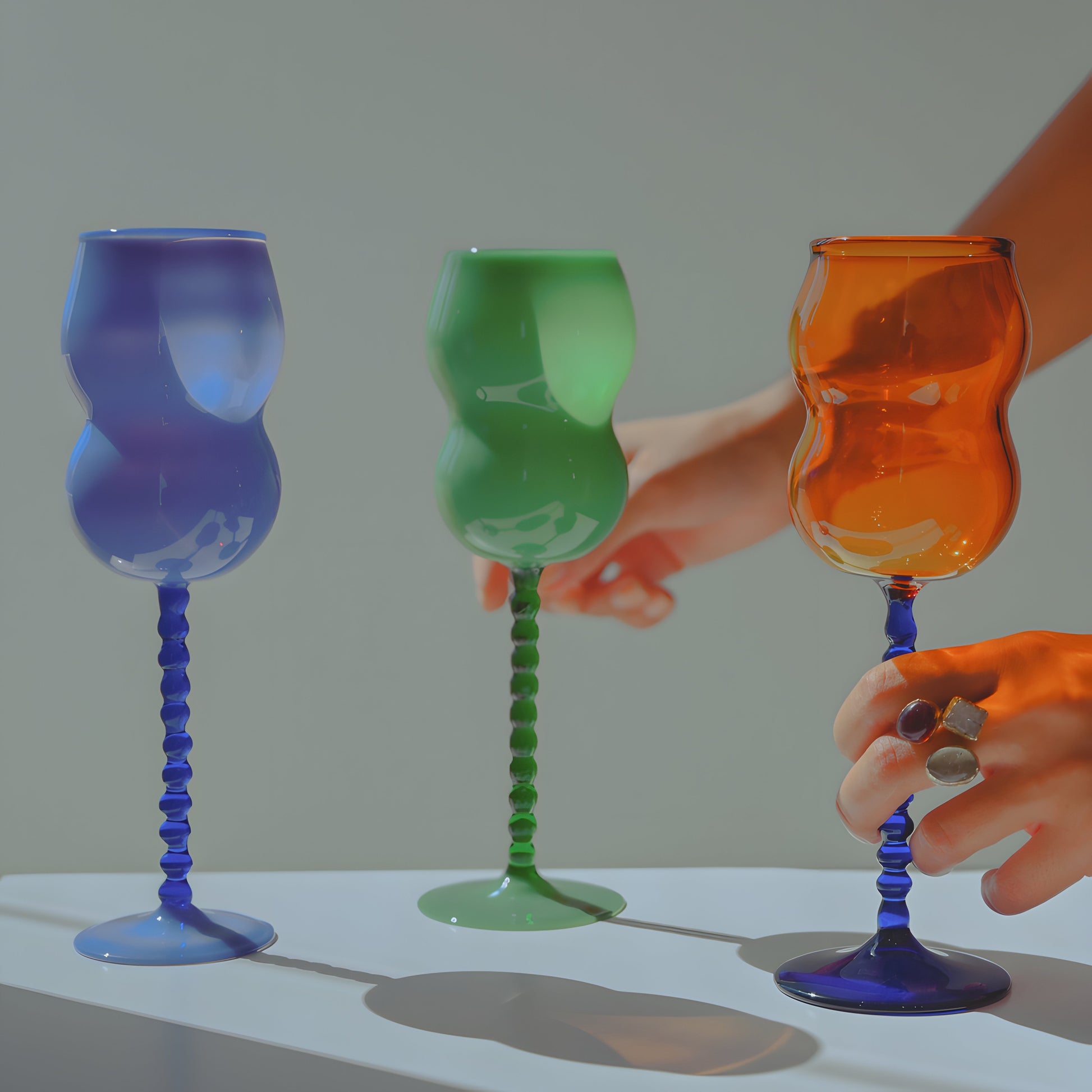 Dreamlike wine glasses captured by for Ornamental by Lameice. Image reflects the whimsical charm and delicate craftsmanship of handmade Palestinian glassware, showcasing a blend of color, light, and poetic design.