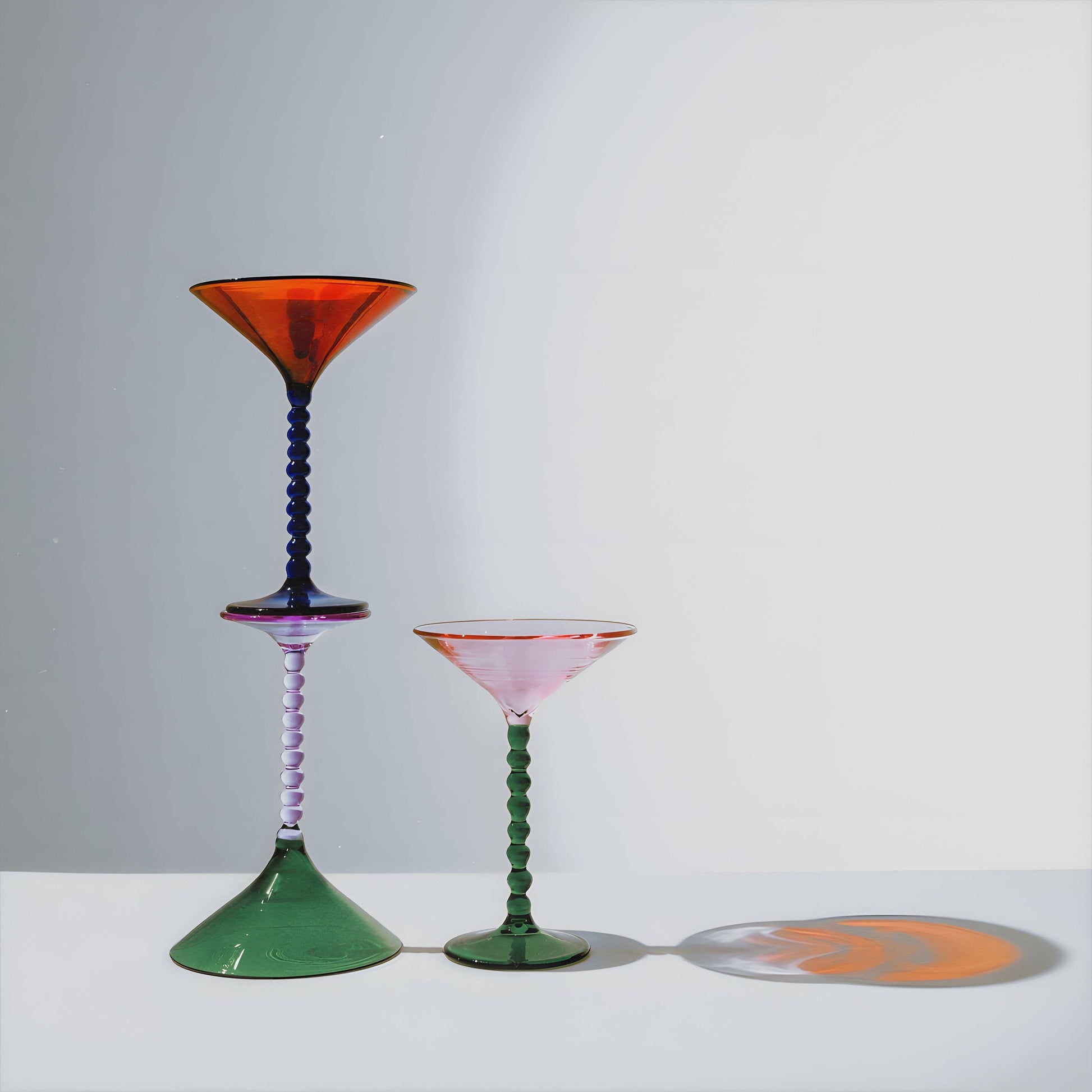 Martini Glass Trio featuring three colorful, vintage-inspired martini glasses with unique stems and vibrant hues, perfect for modern tableware.
