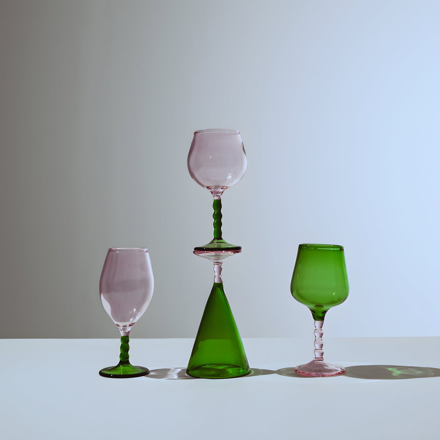 Teta Edit Liquor glasses set with pink and green glassware, showcasing an elegant handcrafted design with a modern artistic touch.