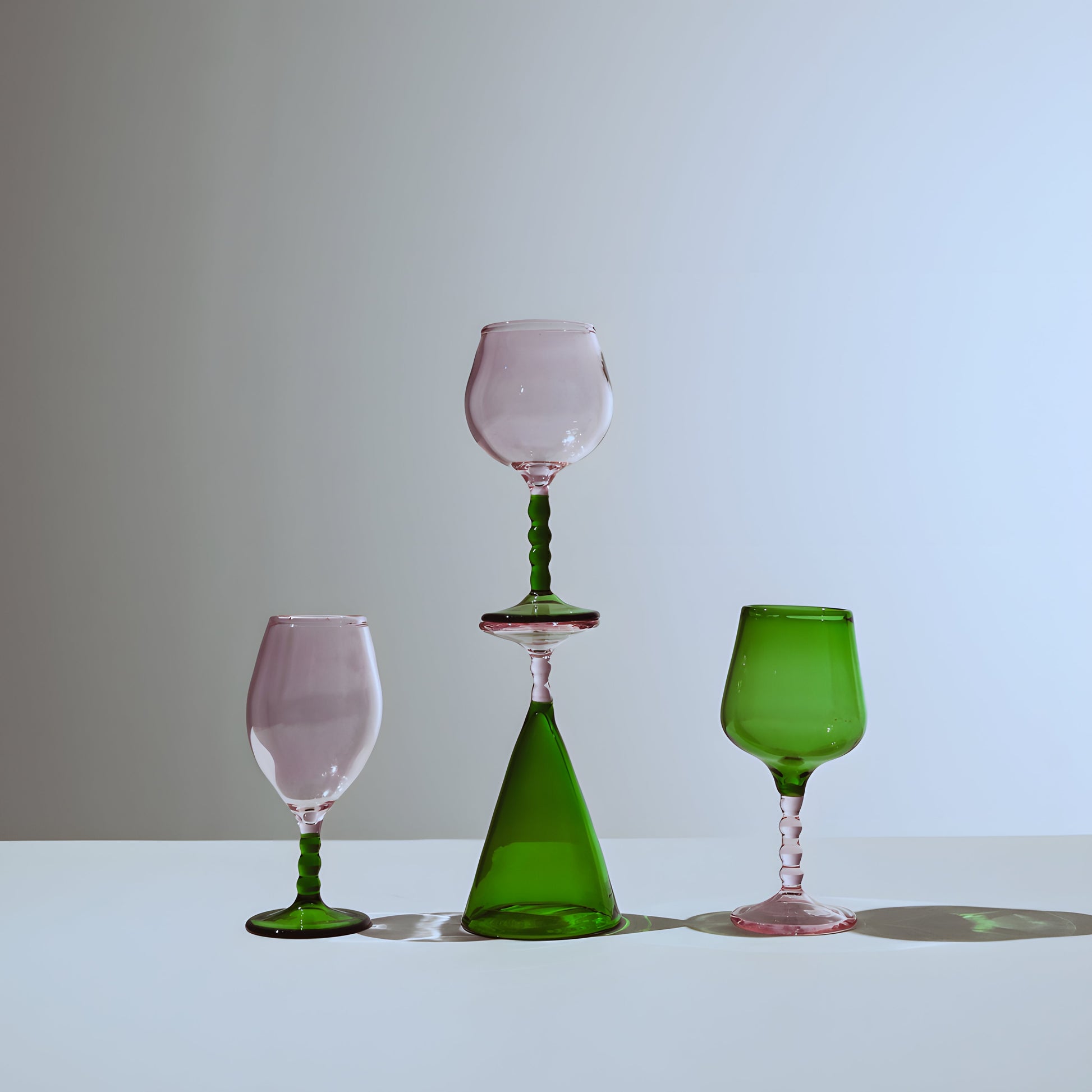 Teta Edit Liquor glasses set with pink and green glassware, showcasing an elegant handcrafted design with a modern artistic touch.