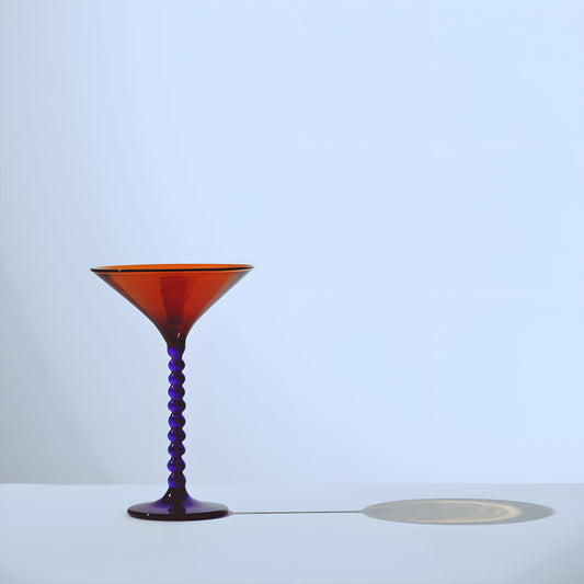 Handcrafted Martini Glass from the Teta Edition featuring a vibrant amber bowl and twisted purple stem, perfect for elegant barware.