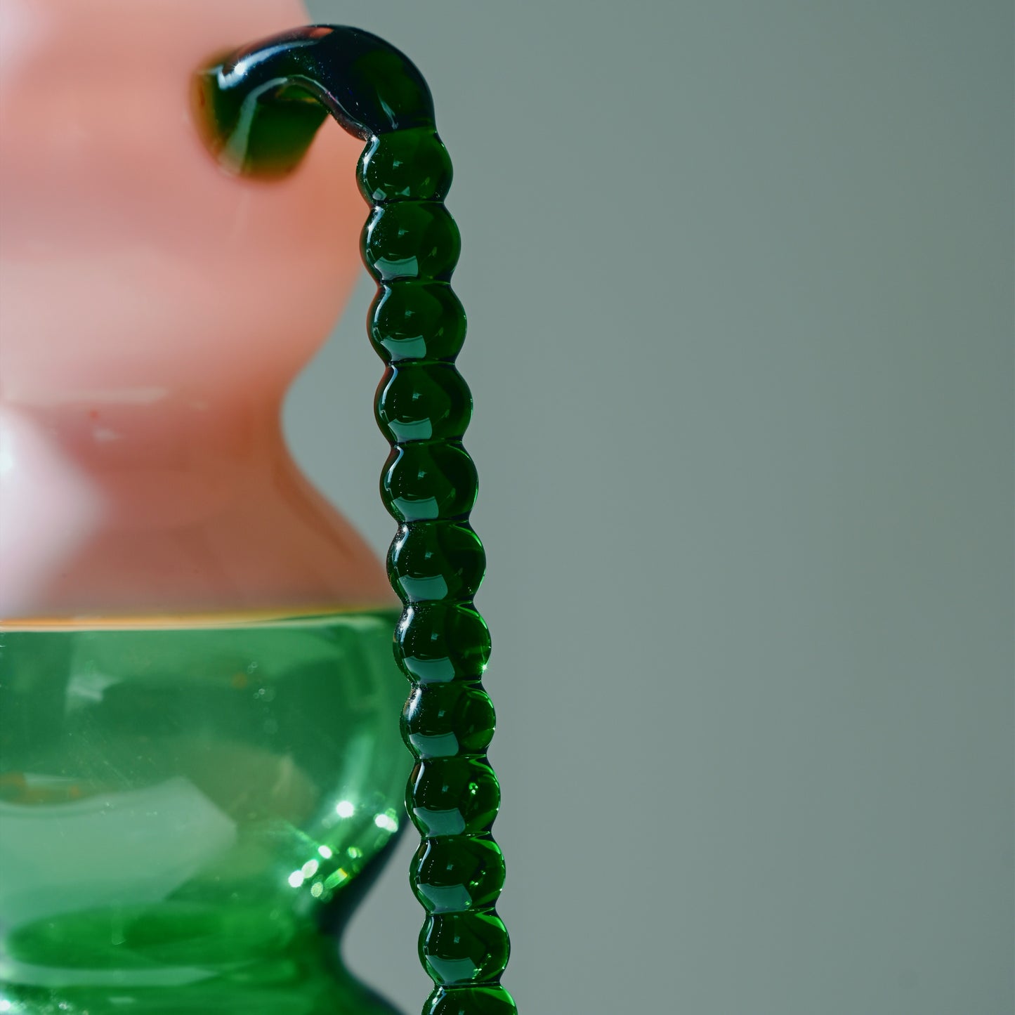 Dreamlike Pitcher:  A handcrafted glass pitcher with a whimsical silhouette, blending fluid curves and bold color contrasts. Mouth-blown by artisans, its ethereal form plays with transparency and light, adding an artful touch to any table setting.