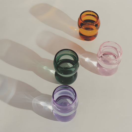 Dreamlike up Quartet cups in vibrant colors of orange, green, pink, and purple with curvy, feminine forms and ethereal design.