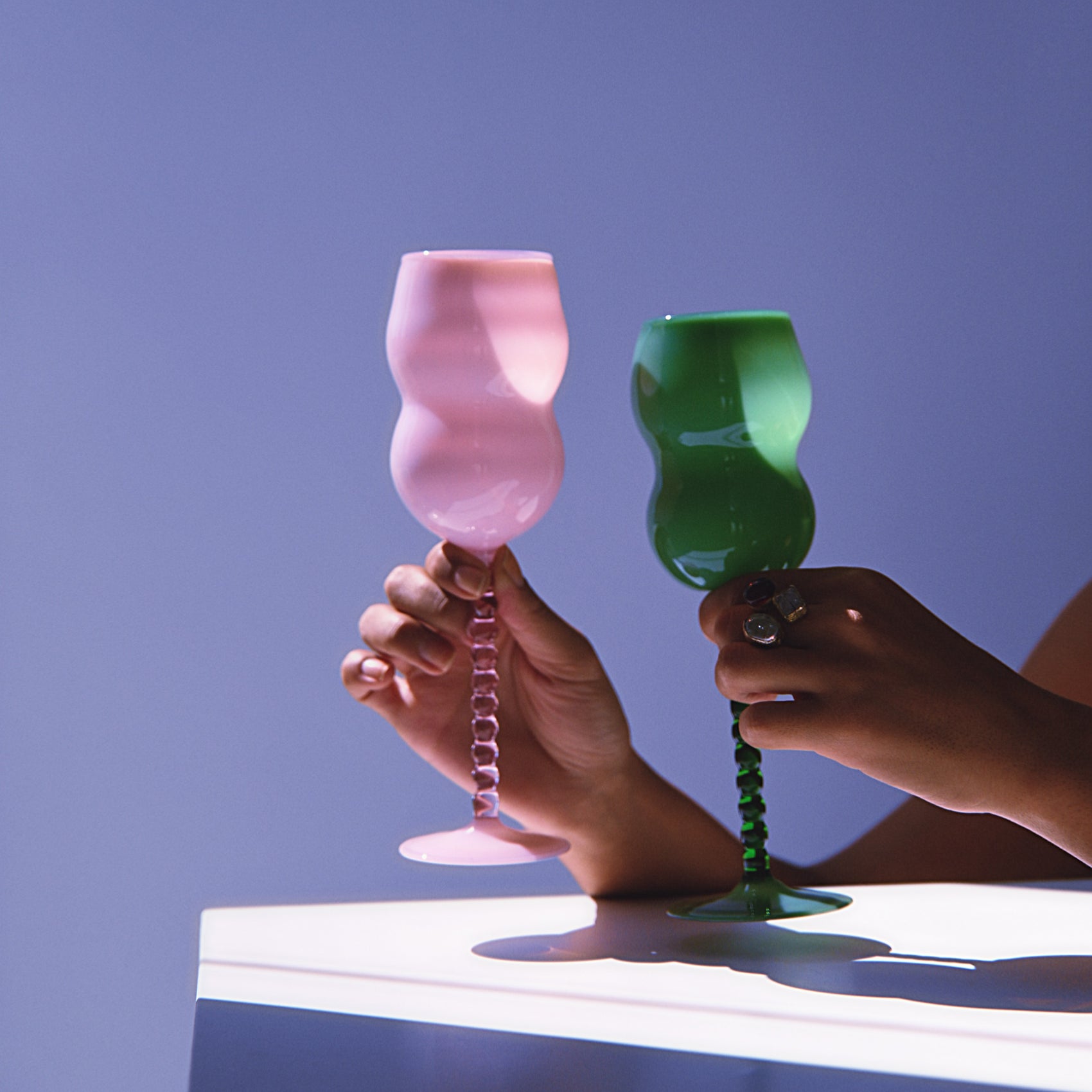 Elegant Dreamlike Wine Glasses in pink and green with artistic wavy stems, perfect for modern tableware in kitchen and dining decor.